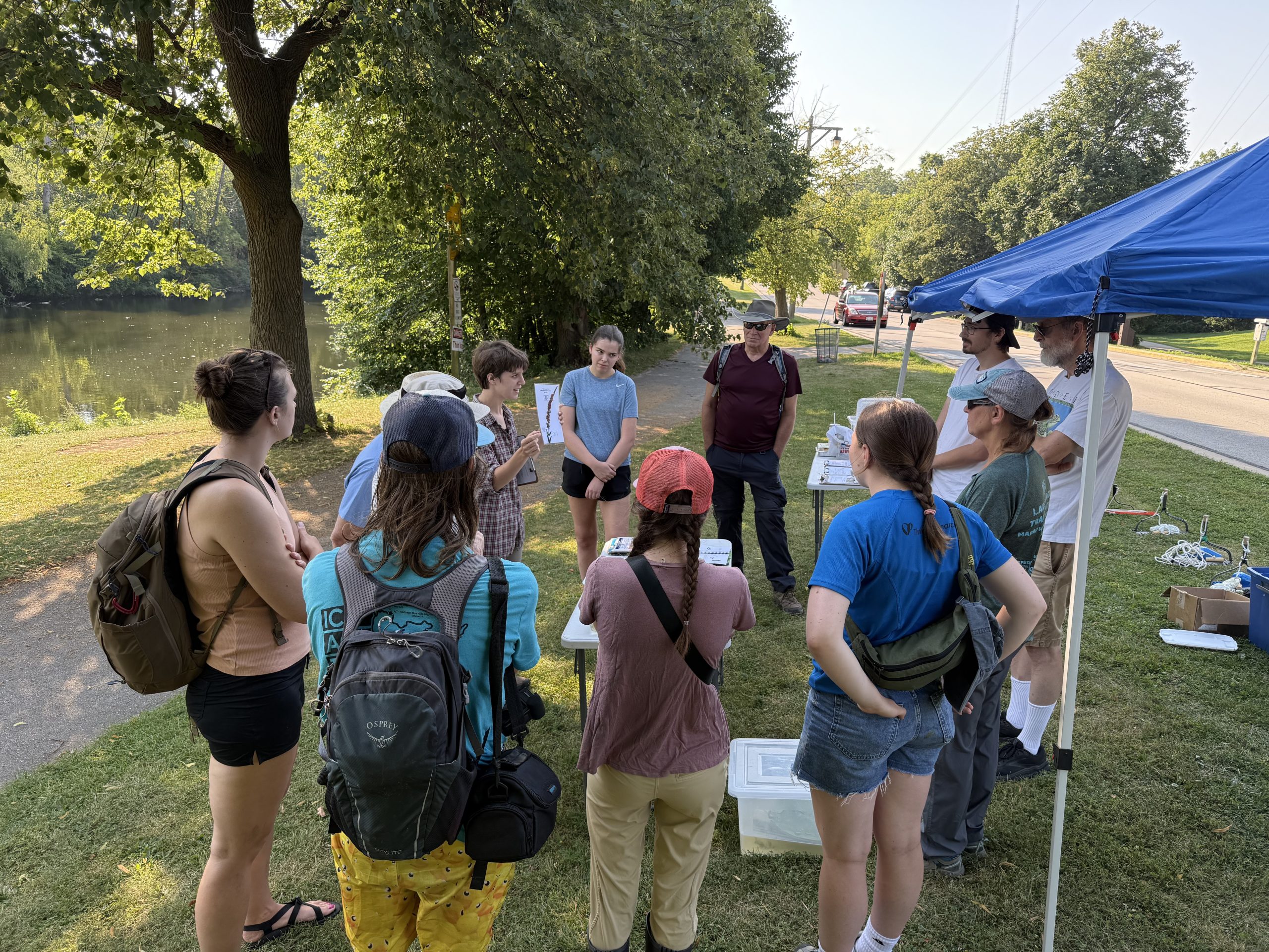 A group of volunteers look on as a volunteer explains the day's activities. 